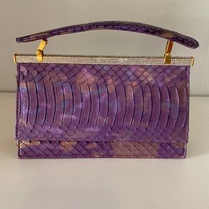 Ashneil clutch in iridescent purple faux leather.